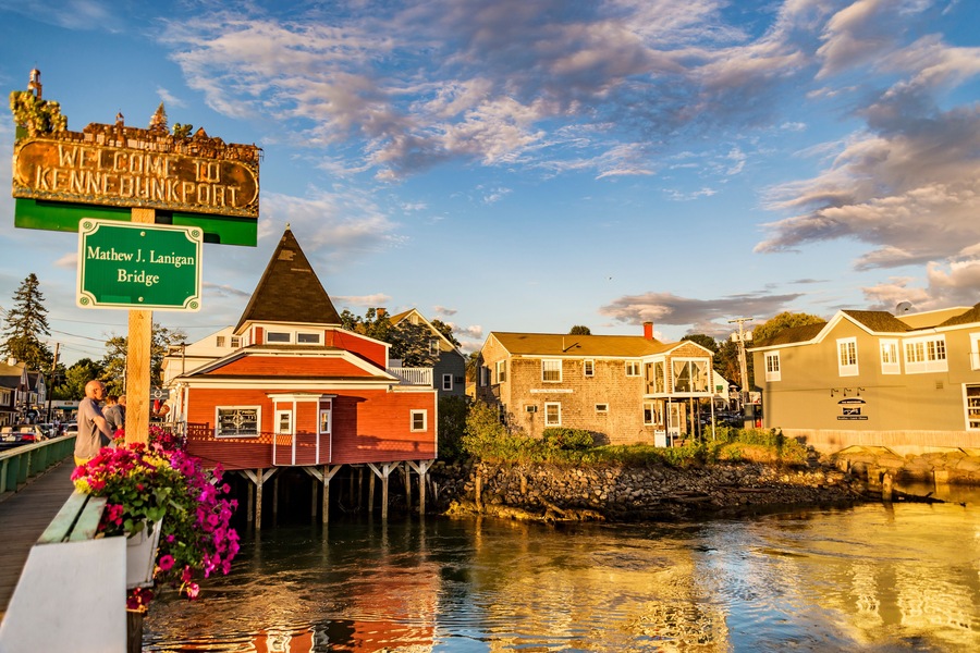 A waterfront town with a sign reading 'Welcome to Kennebecport' and 'Mathew J. Lanigan Bridge.'