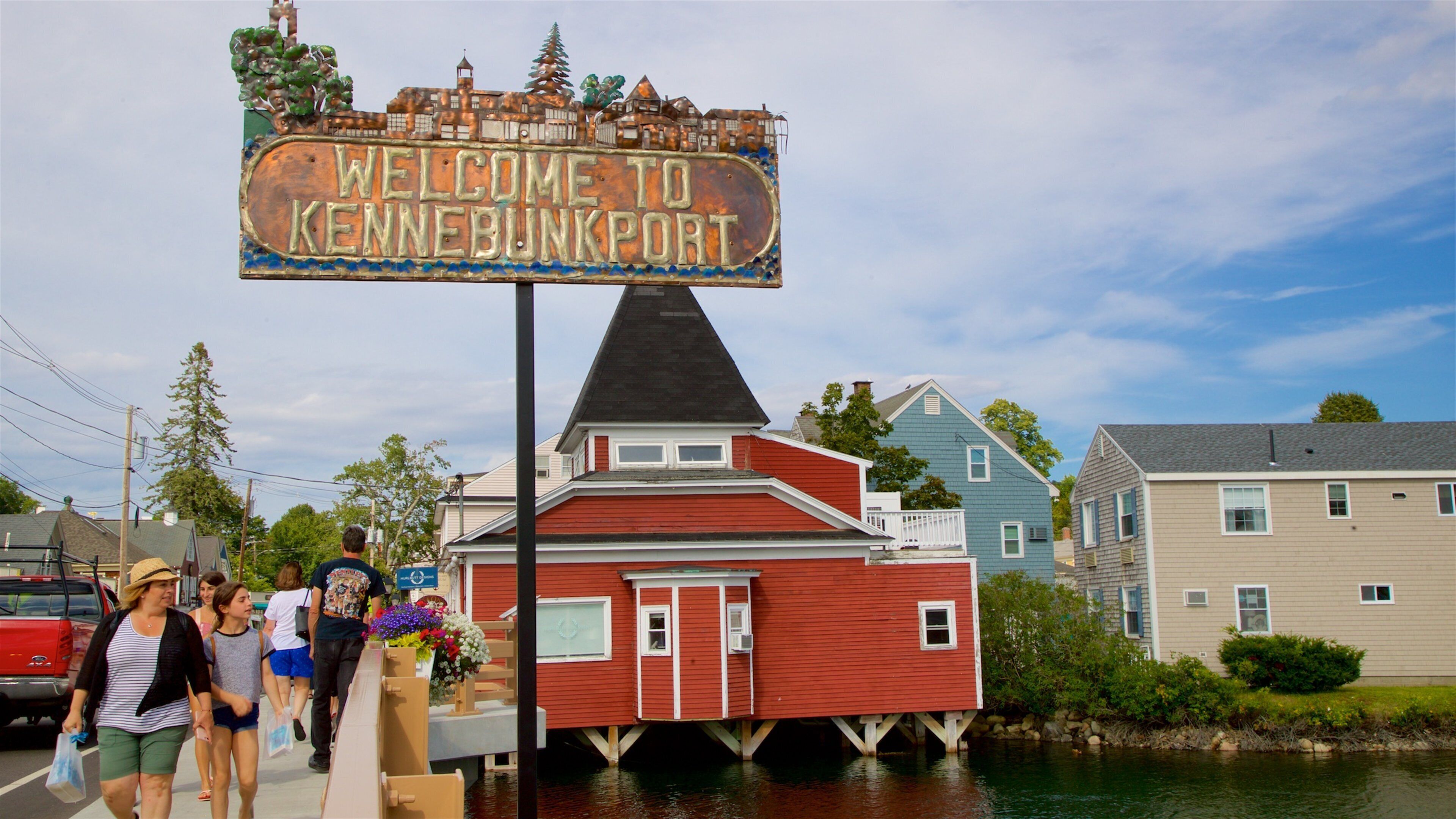 A red building with a sign that reads "Welcome to Kennebunkport."