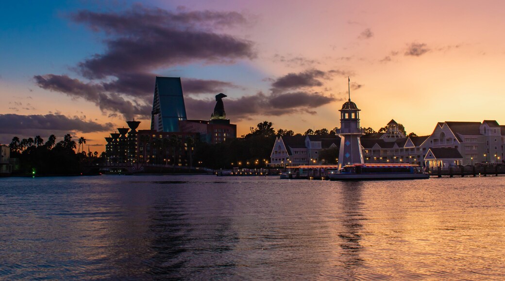 Orlando, Florida. October 11, 2019. Colorful hotel, lighthouse and villas on colorful sunset background at Lake Buena Vista 52.