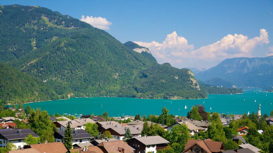 A lake surrounded by mountains and houses.