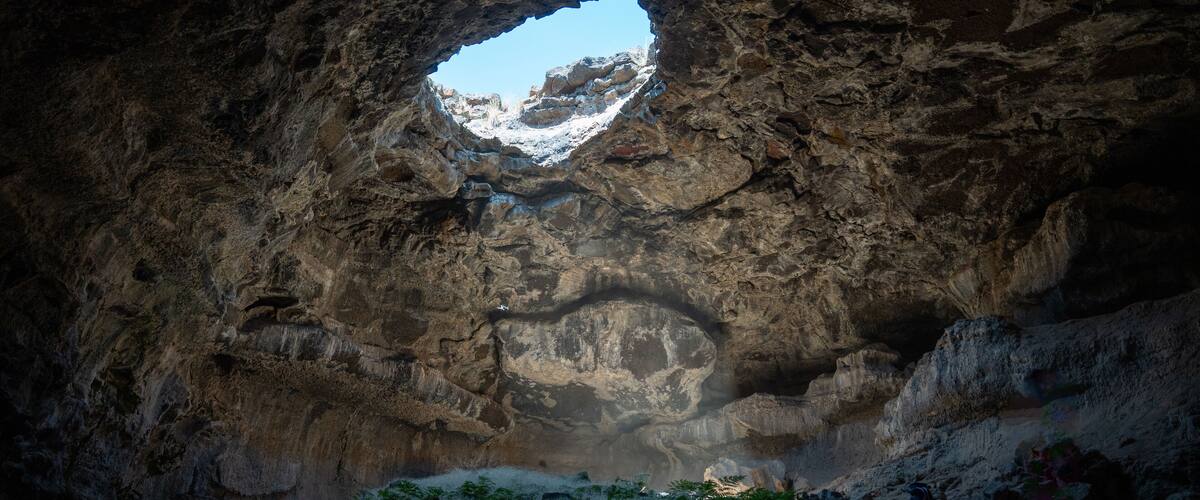 Tea Kettle Cave in Good, Idaho. This cave is open just like the top of a tea pot and is located in a hidden oasis in the southern Idaho desert in the western part of the United States.