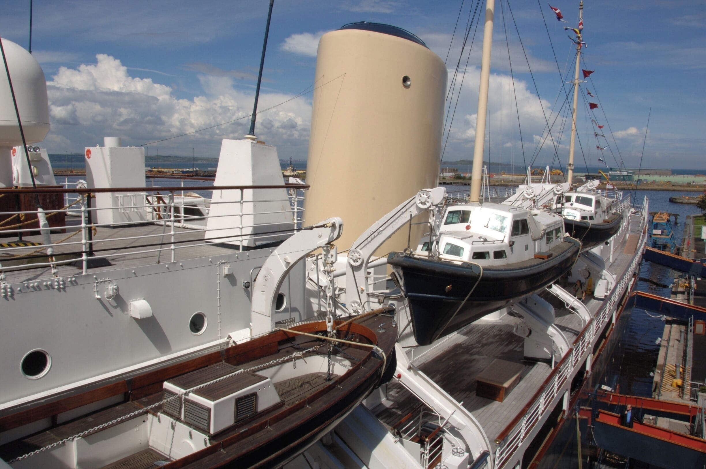 Her Majesty's Yacht Britannia, also known as the Royal Yacht Britannia, is the former royal yacht of the British monarch, Queen Elizabeth II, in service from 1954 until 1997. She was the 83rd such vessel since King Charles II acceded to the throne in 1660, and is the second royal yacht to bear the name, the first being the racing cutter built for the Prince of Wales in 1893. During her 43-year career, the yacht travelled more than a million nautical miles around the globe. Now retired from royal service, Britannia is open to visitors and is permanently berthed at Ocean Terminal, Leith, in Edinburgh, Scotland.