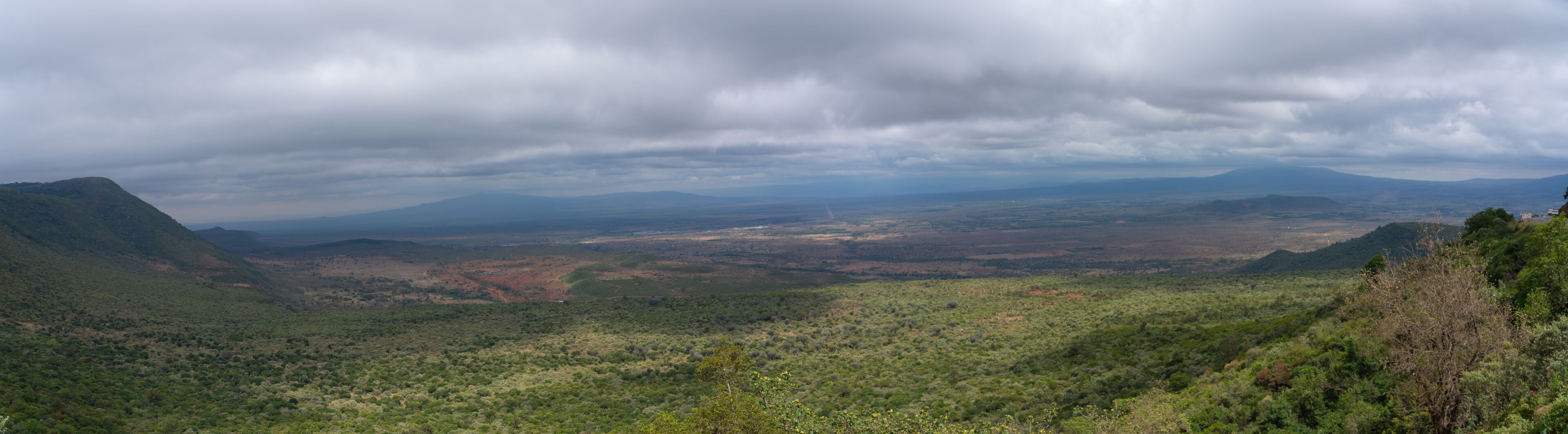 A mountainous landscape with dense vegetation and a valley.