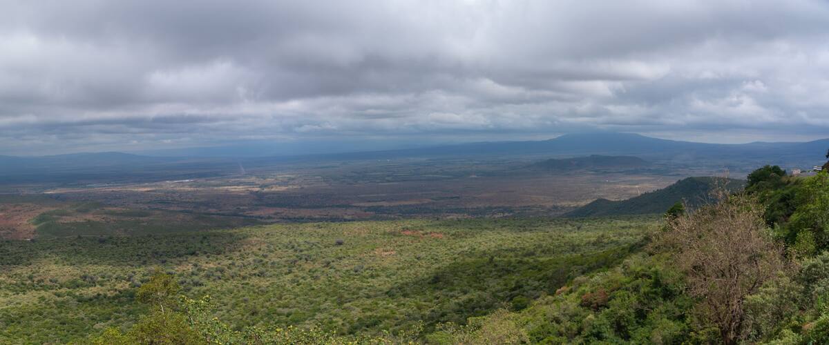 A mountainous landscape with dense vegetation and a valley.