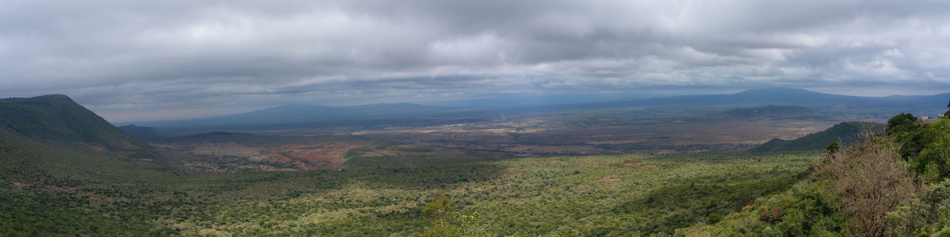 A mountainous landscape with dense vegetation and a valley.