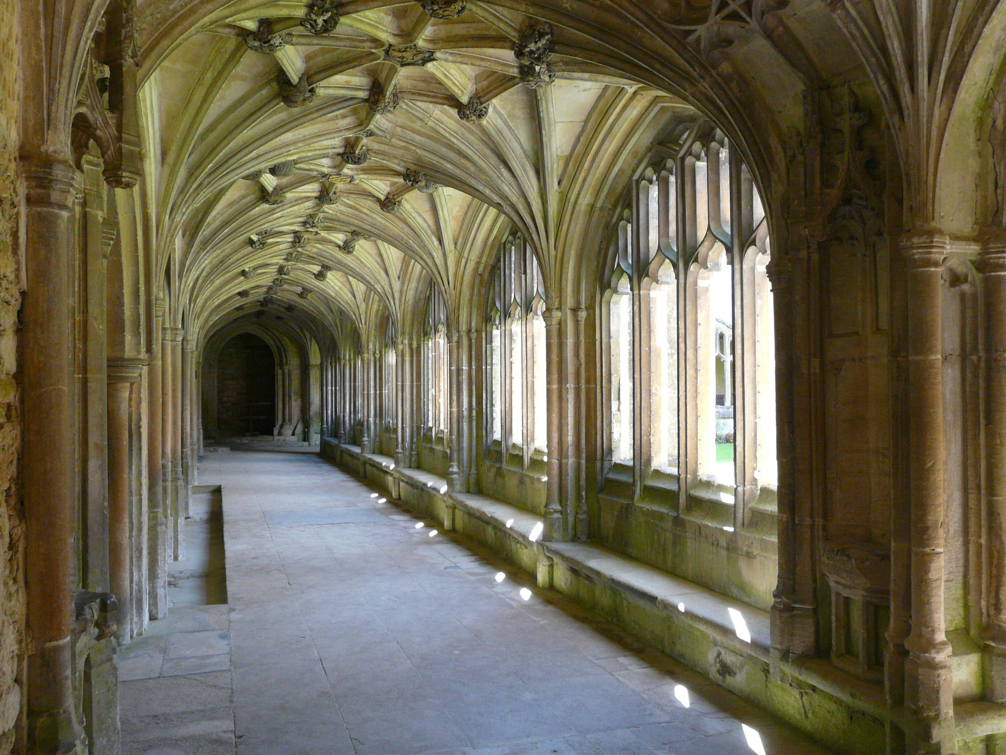 A long corridor with arched ceilings and large windows.