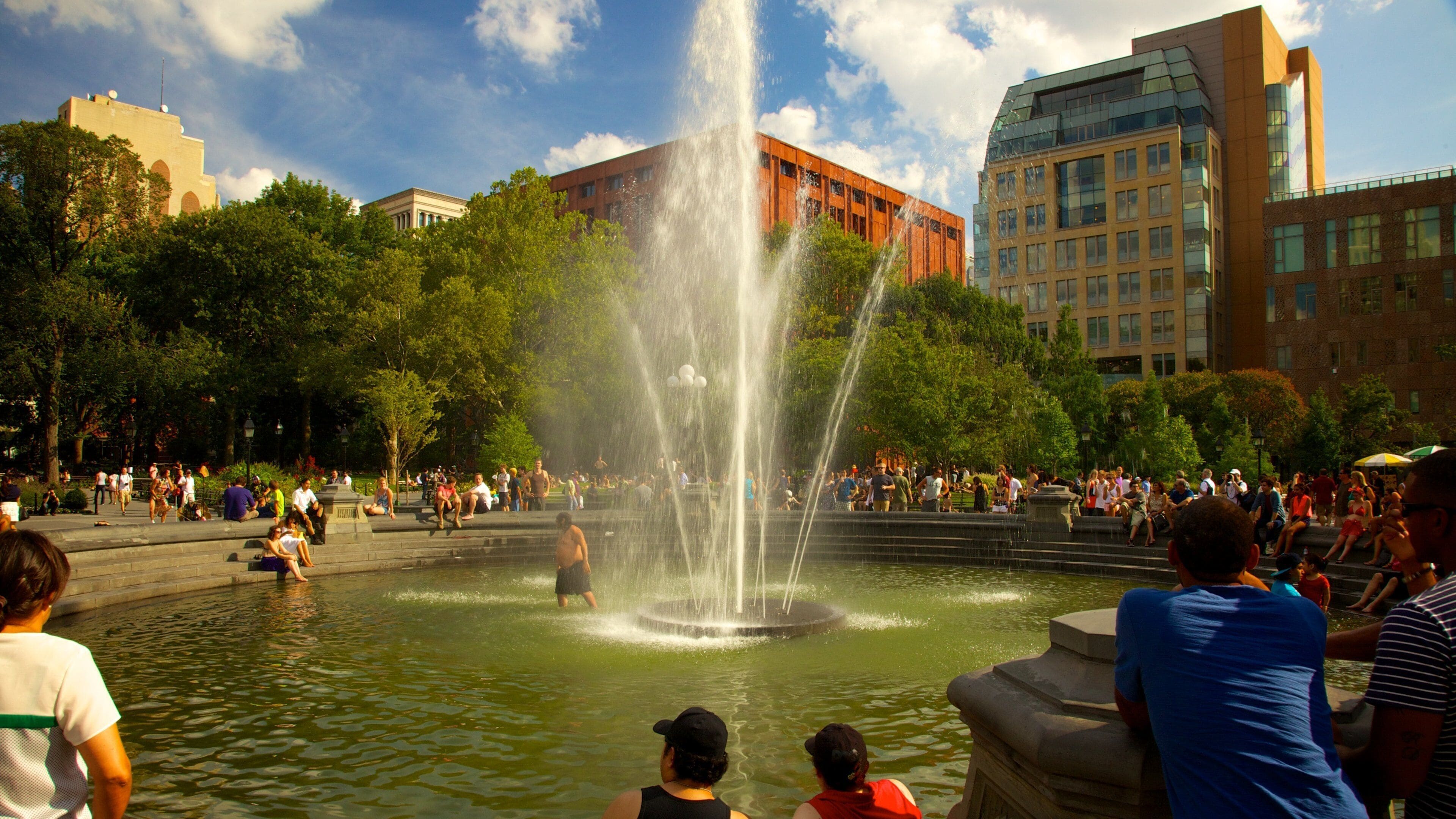 Greenwich Village which includes a fountain and a city as well as a large group of people