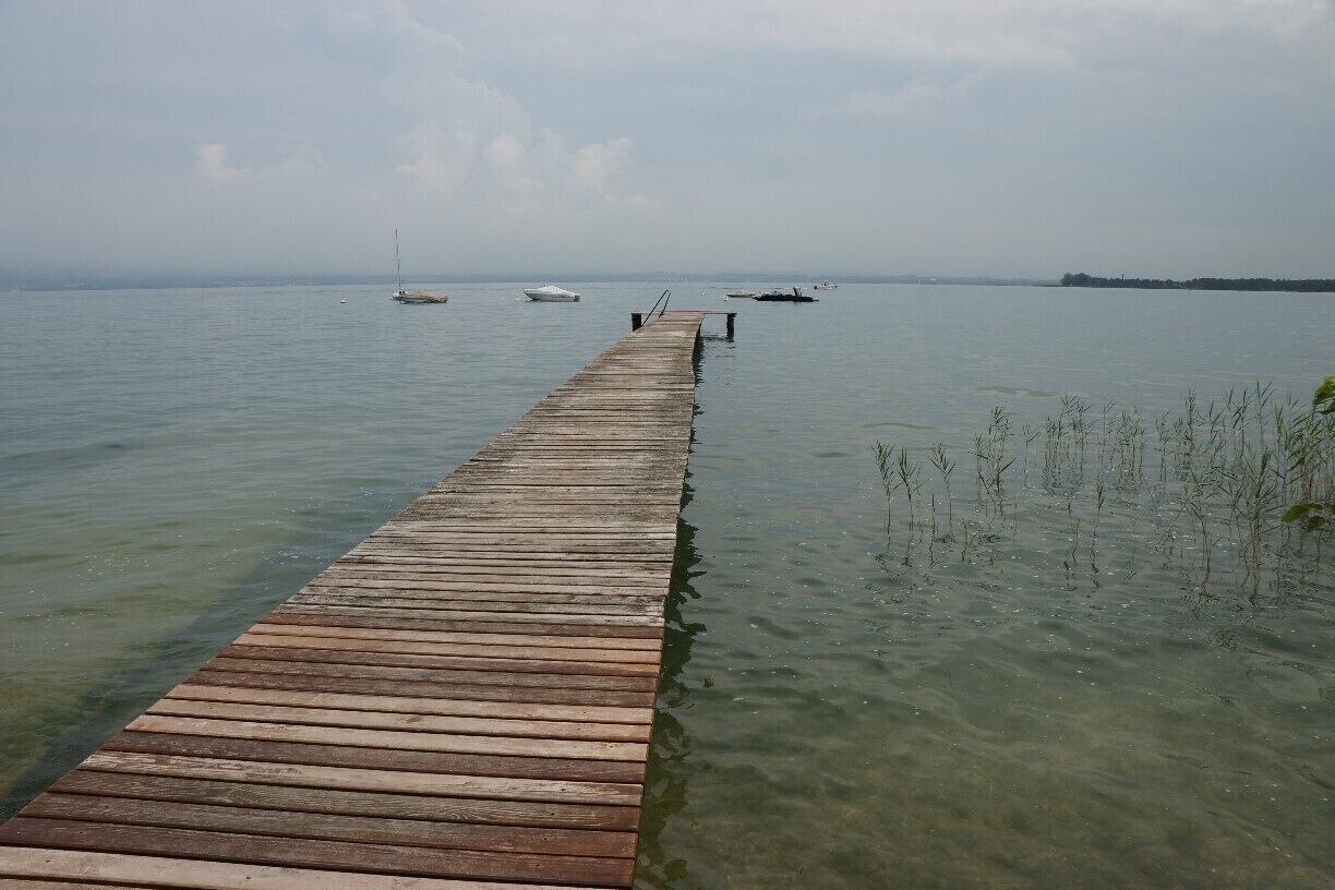 Private Jetty out onto the lake.  There is a beautiful walk along the shore of the lake.  The weather during my stay was very changeable and watching the clouds, then a storm roll in over the lake, with mountains in the background was quite spectacular.

There was an excellent restaurant at this location on the small Marina, that served the best seafood risotto and was completely open to the lake - Trattoria al Porticciolo.  Service was a little slow though very friendly, but the restaurant was very busy and the kitchen delivered quickly.  Would definitely go back.