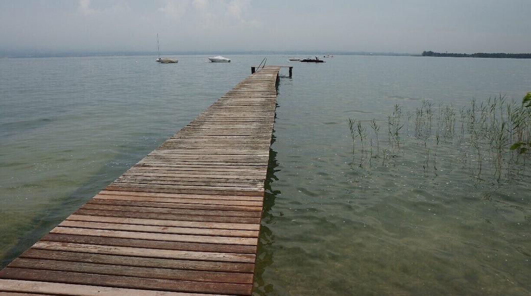 Private Jetty out onto the lake. There is a beautiful walk along the shore of the lake. The weather during my stay was very changeable and watching the clouds, then a storm roll in over the lake, with mountains in the background was quite spectacular.
There was an excellent restaurant at this location on the small Marina, that served the best seafood risotto and was completely open to the lake - Trattoria al Porticciolo. Service was a little slow though very friendly, but the restaurant was very busy and the kitchen delivered quickly. Would definitely go back.