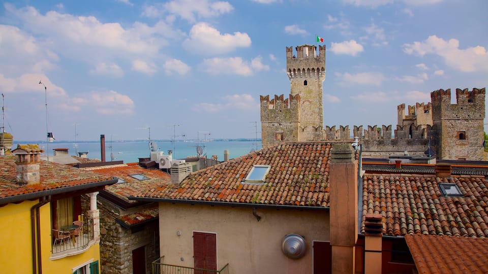 A coastal town with historic stone towers and terracotta rooftops.