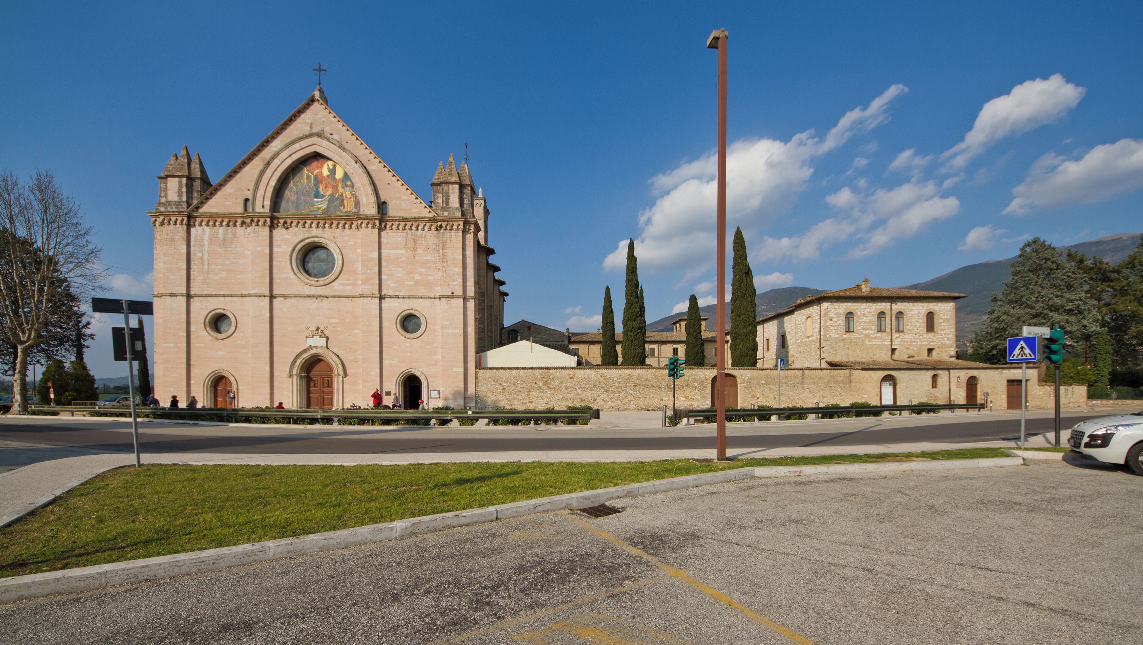 A historic church with a prominent bell tower and a large circular window.