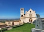 A historic church with a bell tower and a statue of a knight.