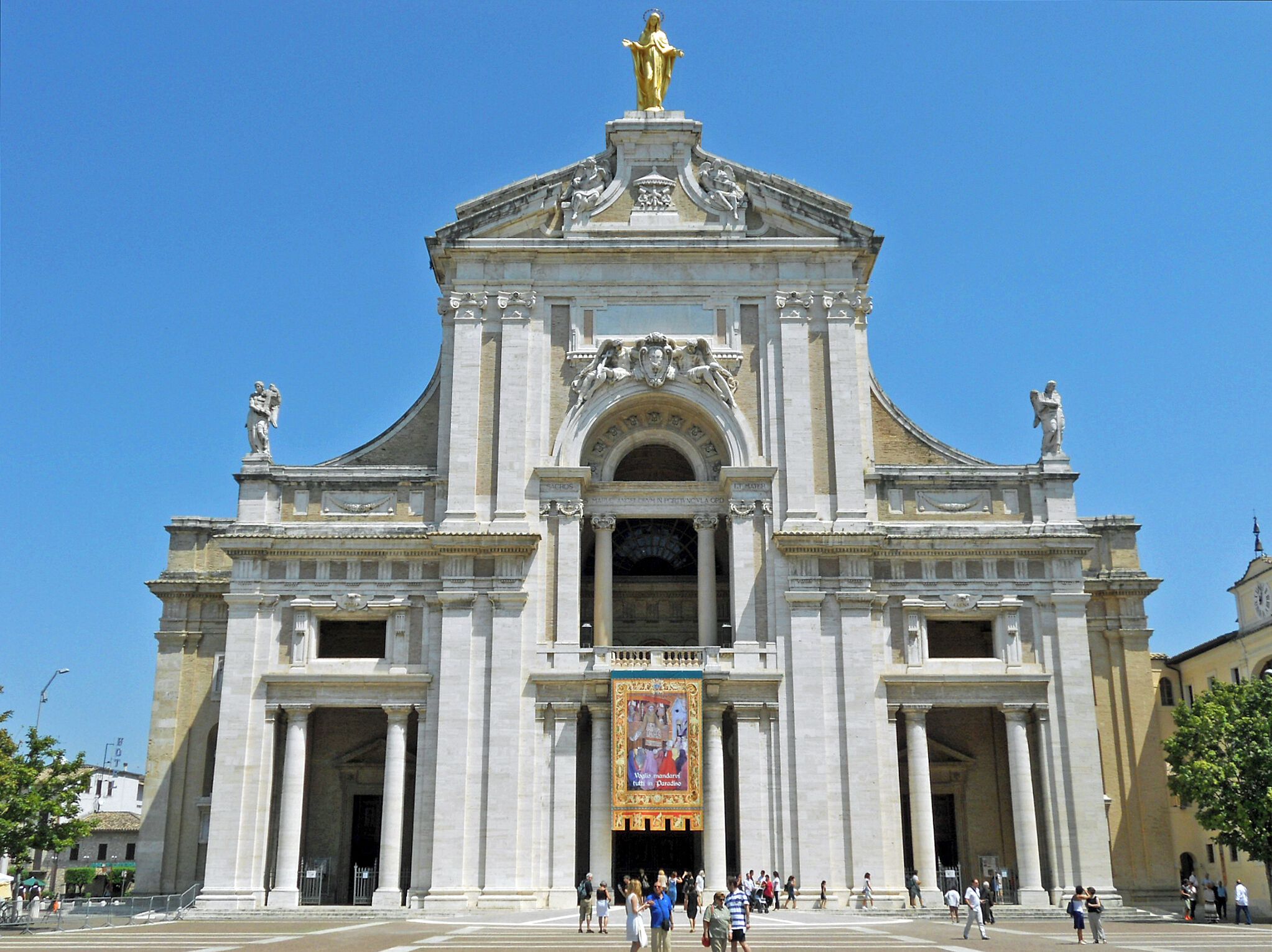 A grand historical building with classical architecture, featuring large columns, statues, and an ornate entrance.