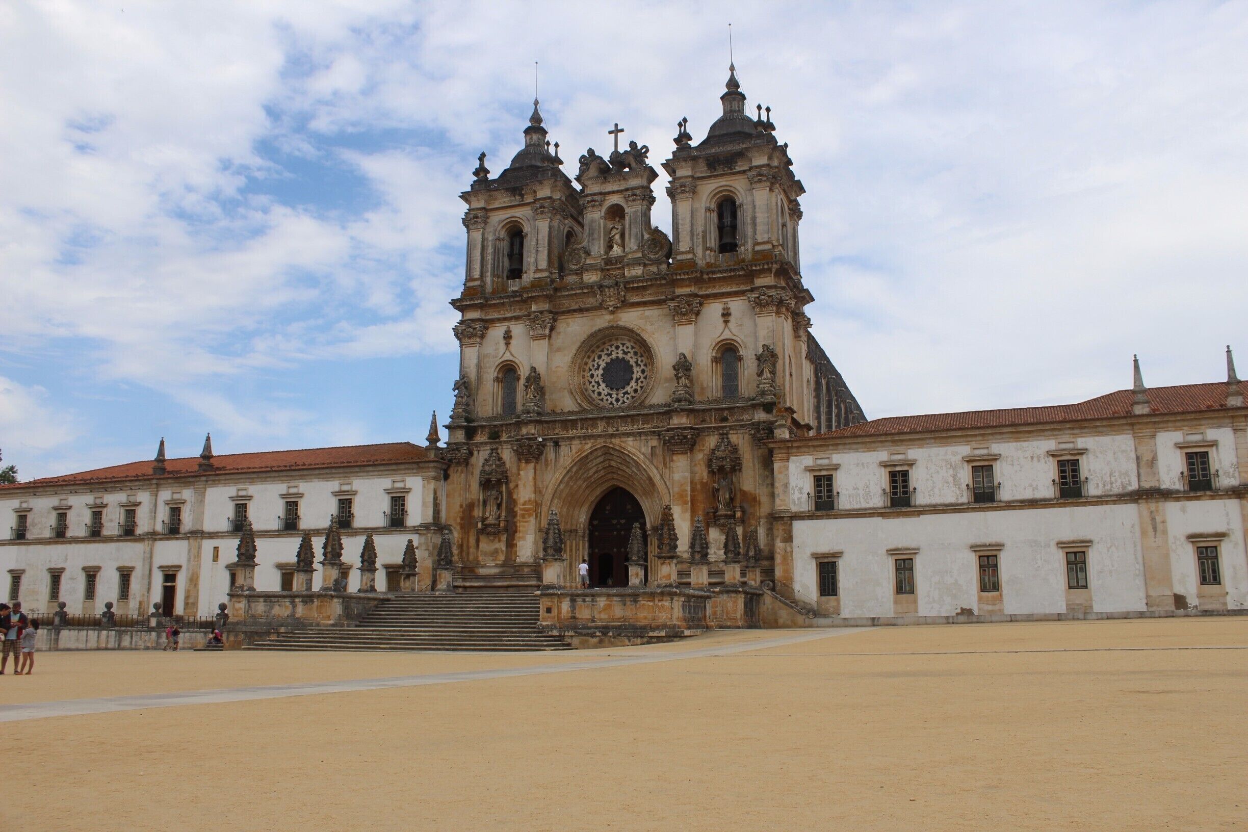 A historic cathedral with a large central dome and two bell towers.
