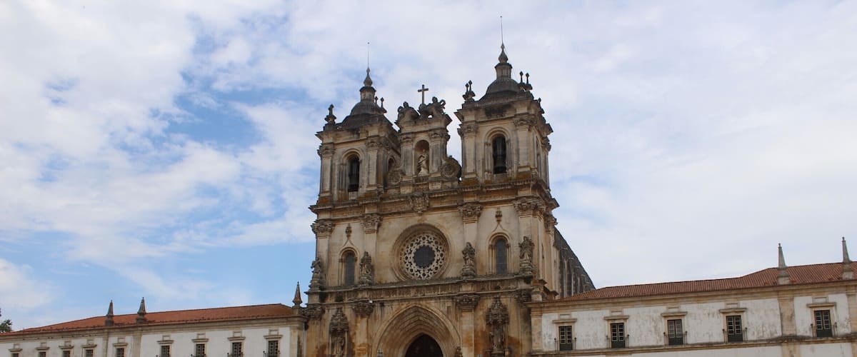 A historic cathedral with a large central dome and two bell towers.