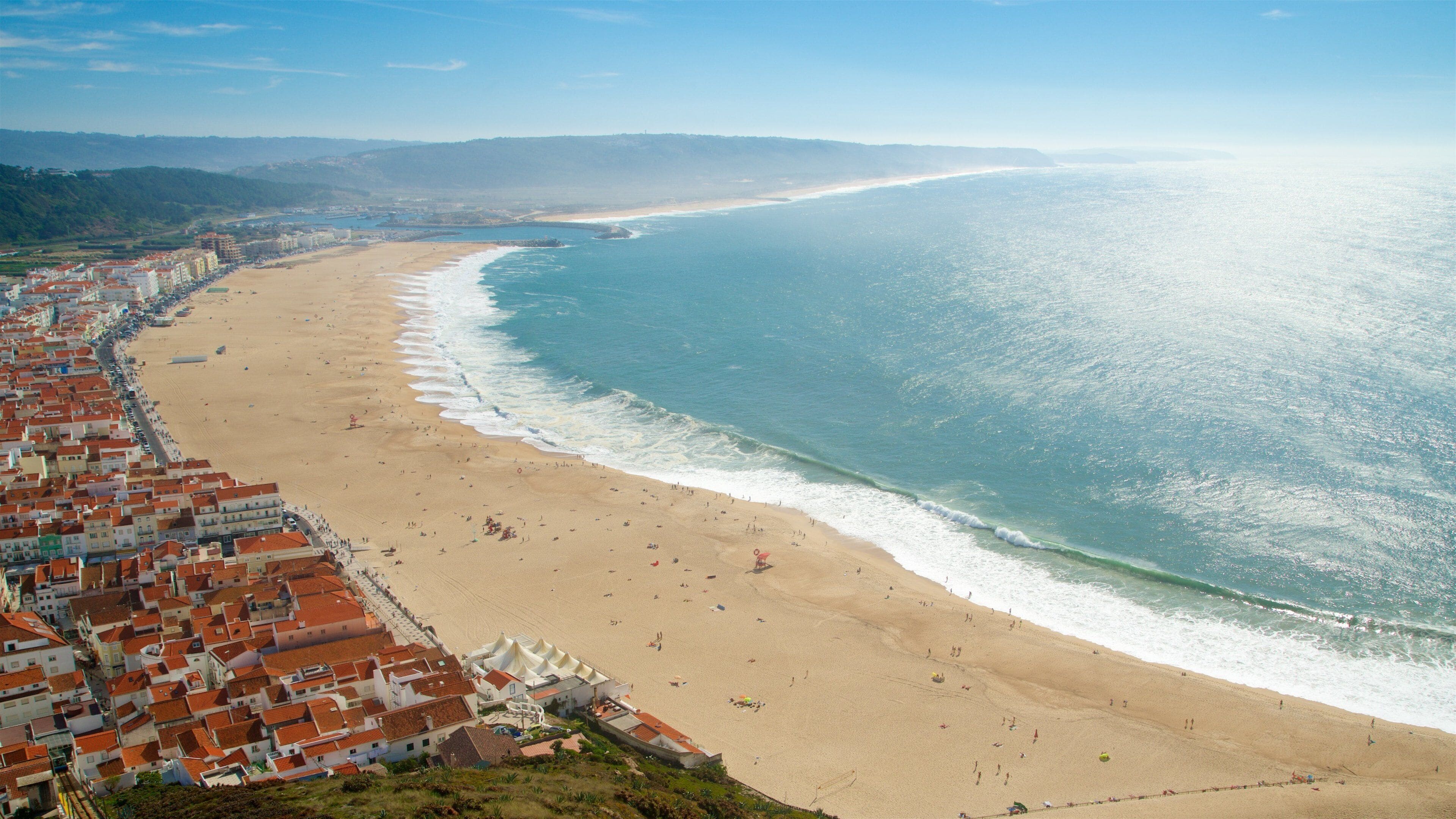Nazare showing a sandy beach, general coastal views and a coastal town