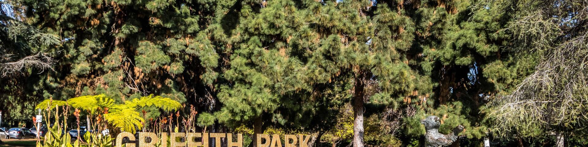 Griffith Park sign and bear statue - Los Angeles, California, USA