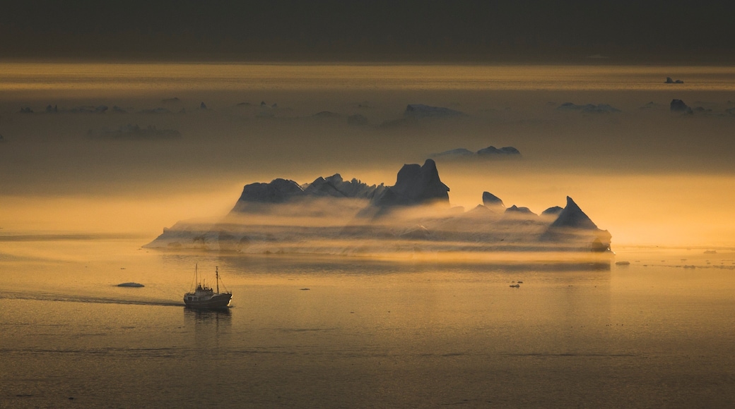 Greenland featuring general coastal views, a sunset and snow
