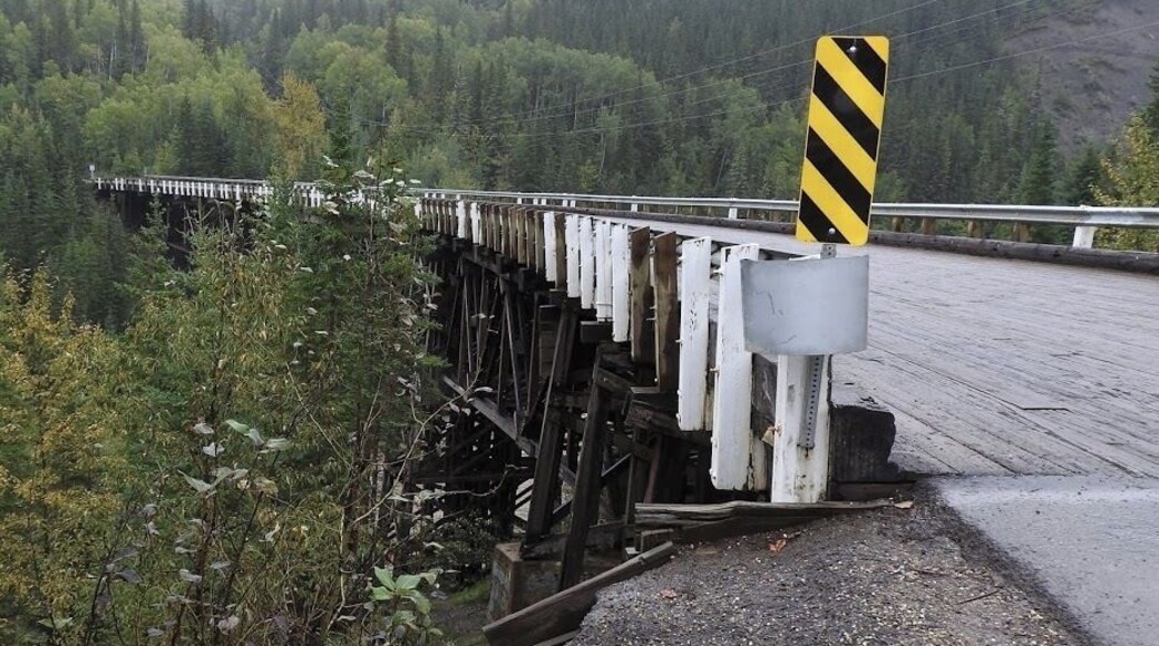 Construction of the Historic Kiskatinaw Bridge began in late 1942. It was one of 133 permanent bridges constructed by the US Public Roads Administration (PRA) to replace the temporary crossings used by the US Army to build the pioneer road. This three-span timber truss bridge has an amazing nine-degree curve – a curve that PRA engineers designed to accommodate the highway’s steep change in grade on the west end and the need to land at a notch in the cliff on the east end. At the time, it was the first wooden curved bridge to be built in Canada. Development of the oil and gas industry in the post war years resulted in the need for a new bridge to handle wider and heavier loads; as a result, the Alaska Highway was rerouted in 1978, bypassing approximately 10 km of the old highway and the historic bridge.
#historic #bridge #GreatOutdoors #OnTheRoad
