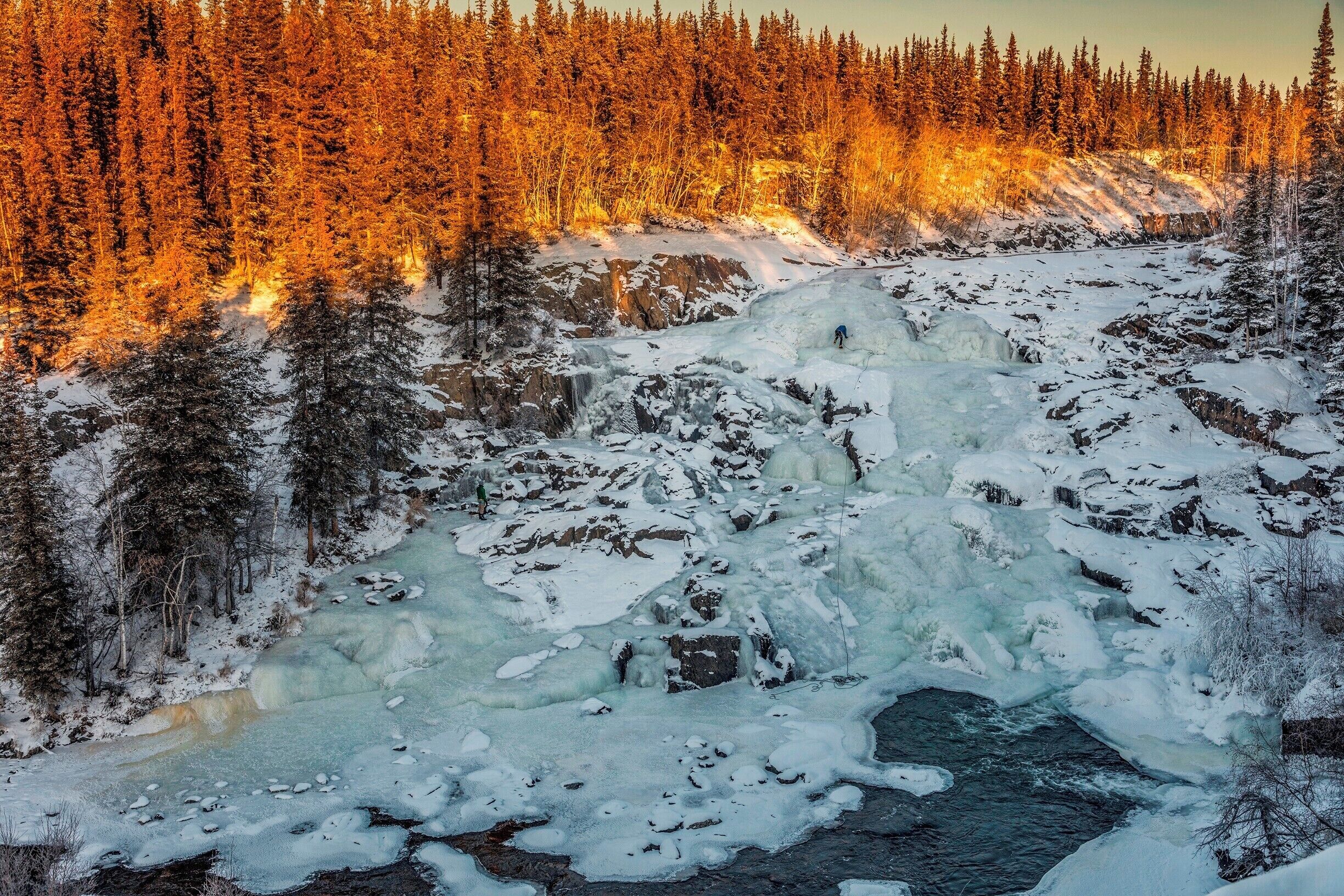 While at my B&B I was told of Cameron Falls. A "15 minute" hike 60 km from Yellowknife. The road out there is the road that leads to a ice road, the one used in Ice Road Truckers. 

The hike was definitely longer than 15 minutes, even in summer I'd say it was about a 30 minute hike. But can you beat this view?! We got there and watched a couple guys climb the face of the falls. You can even walk around the river some and get to the other side of the waterfall. 