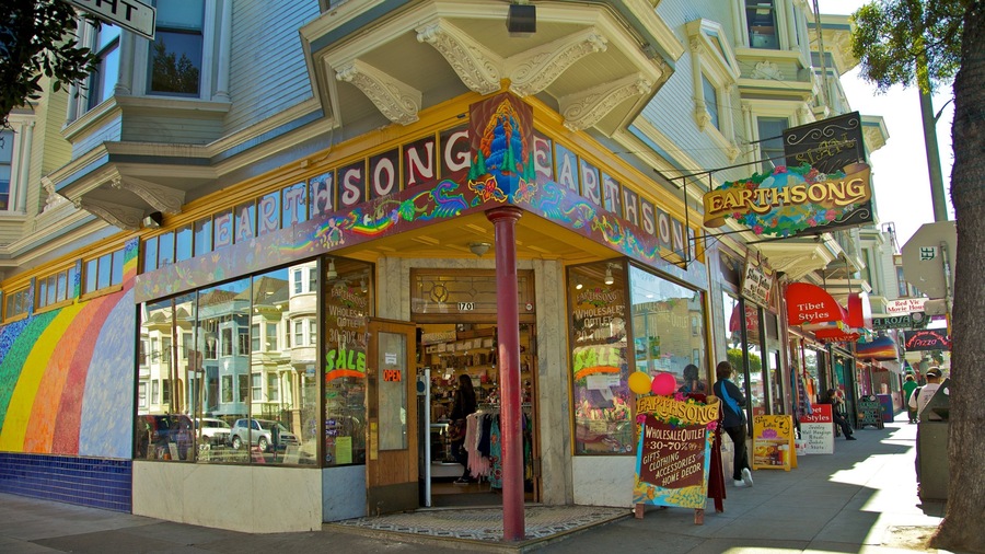 A colorful storefront with a rainbow mural and a sign reading "EARTHSONG".