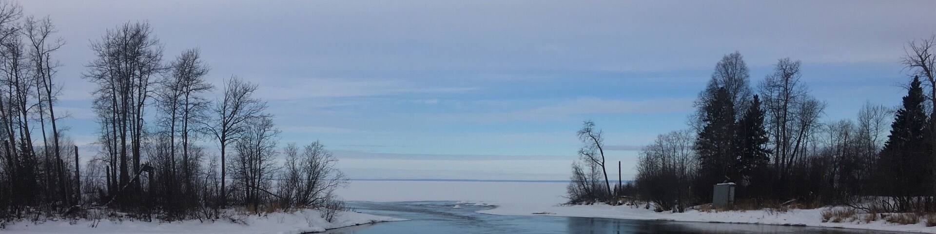 Beginning of March! Ice still on the main lake and we are still on snow machines, Cold river starting to open up more. (Never does freeze tho!)