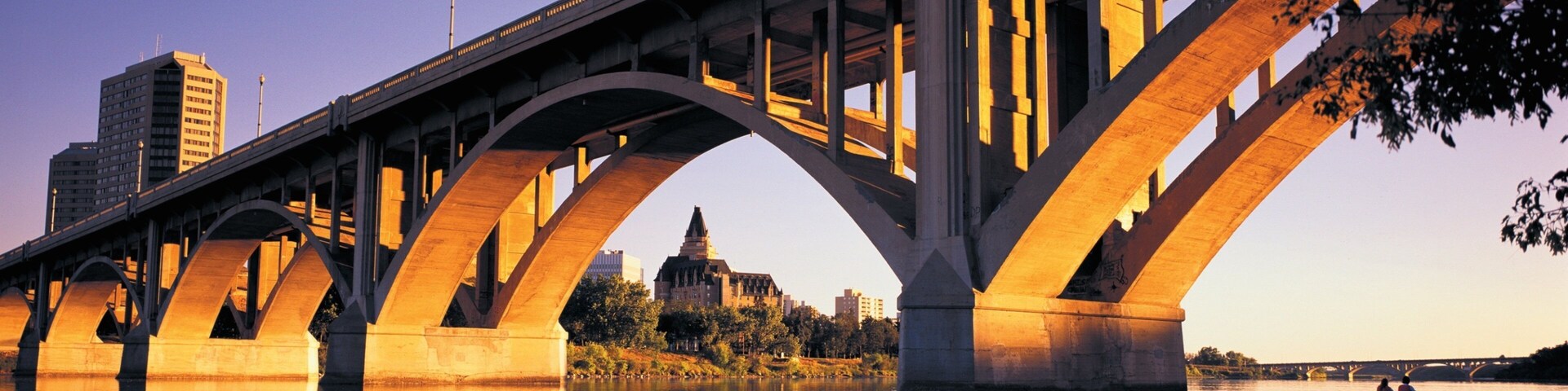 Saskatchewan featuring a river or creek, a bridge and a sunset