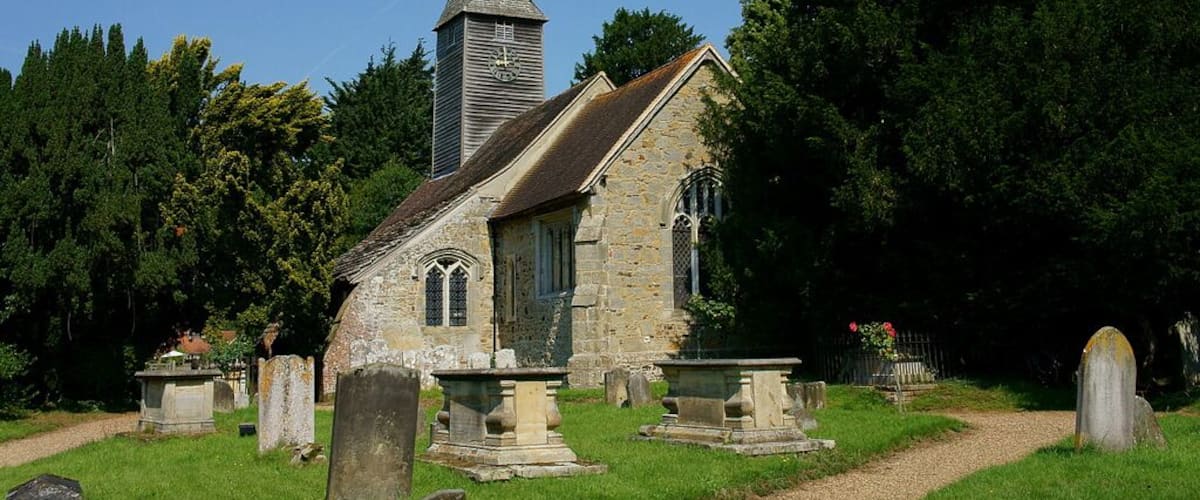 St George's parish church, Crowhurst, Surrey, seen from the southeast. To the right of the church is the Crowhurst Yew, an ancient tree thought to be up to 4000 years old. Despite the trunk being hollow, the tree seems to be in good health.