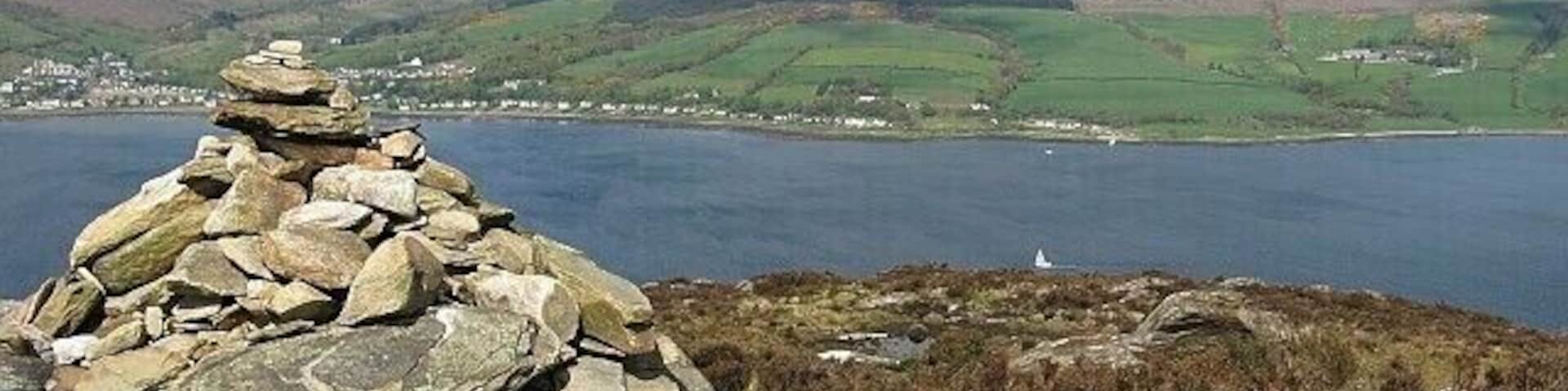 Cairn on Mullach Beag This cairn marks the 246 metre top of Mullach Beag, in the northern half of Holy Isle. Despite its modest height, the hill offers extensive views, particularly across Lamlash Bay to Goat Fell on Arran (towards the right of this photo).
