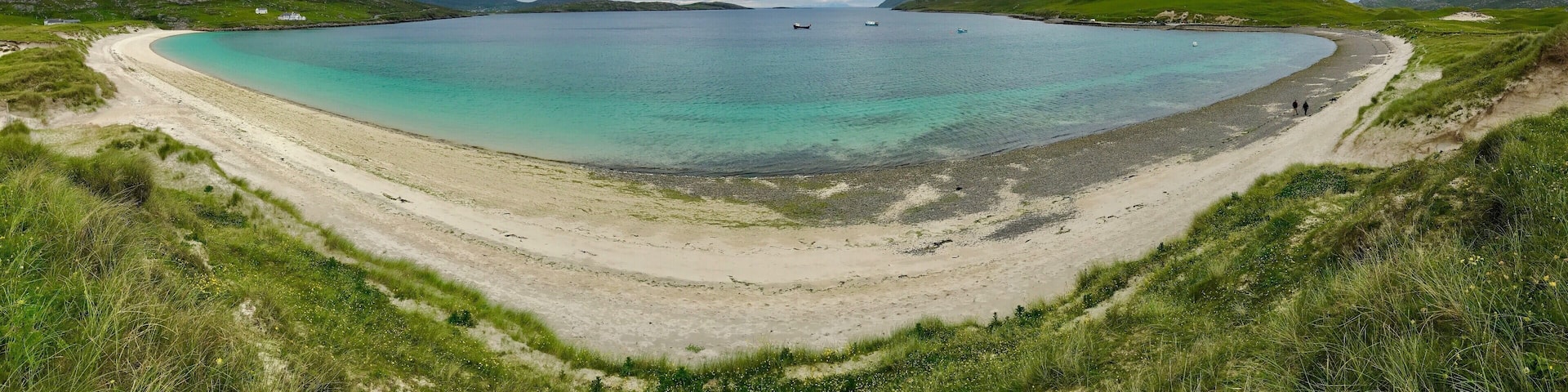 Vatersay East Beach faces the mainland of Scotland and the Isle of Skye with the small Isles to the south. Vatersay East is calmer than it's close neighbor the west side, the perfect places to catch a sunrise on one side and a sunset on the other, Vatersay is now connected by a causeway to the larger Island of Barra to the north.
https://www.undiscoveredscotland.co.uk/vatersay/vatersay/index.html