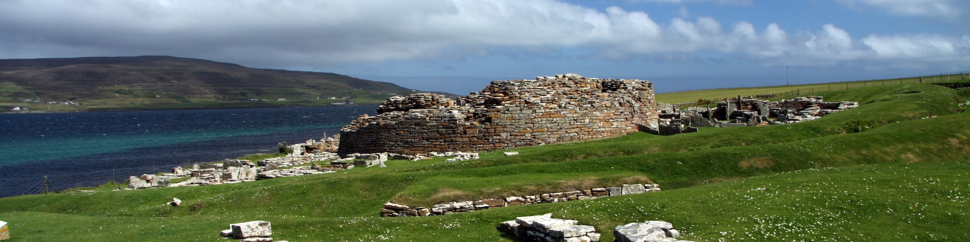 he Broch of Gurness is an Iron Age broch village on the northwest coast of Mainland Orkney in Scotland overlooking Eynhallow Sound.