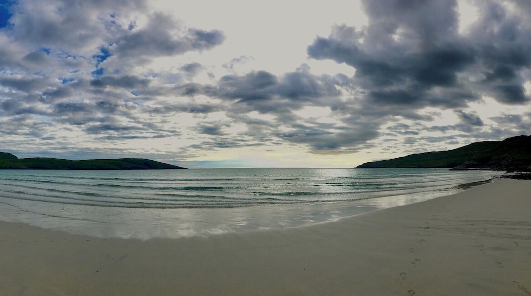 Vatersay is almost the most Southerly island on the Outer Hebrides. It's the most southerly inhabited island though. The west beach faces out to the Atlantic gales and is surrounded by grass covered dunes. the east beach on the other side takes about 5 minutes to get to from here, you can just make out the outlines of the Isle of Skye and the Scottish mainland.
https://www.undiscoveredscotland.co.uk/vatersay/vatersay/index.html