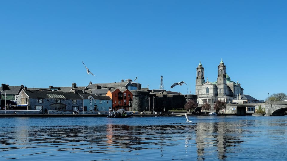 A river with buildings and a bridge.