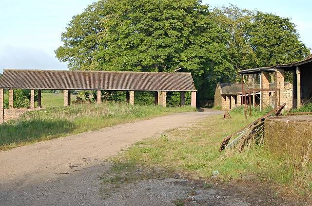 Larennie Farm. The large open sided build on the right was posh silage pit in its day. General view from the west looking out towards Peat Inn