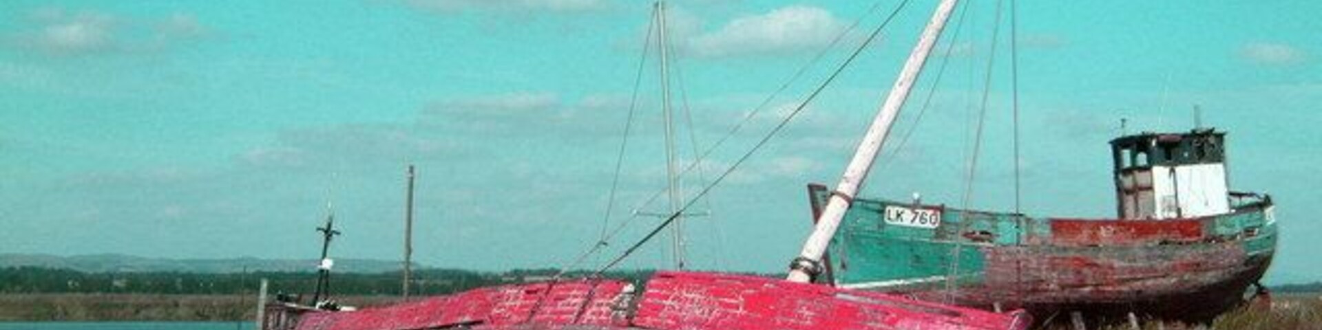 Boat wrecks at Newburgh Harbour Abandoned boats lie near the harbour on the Tay.