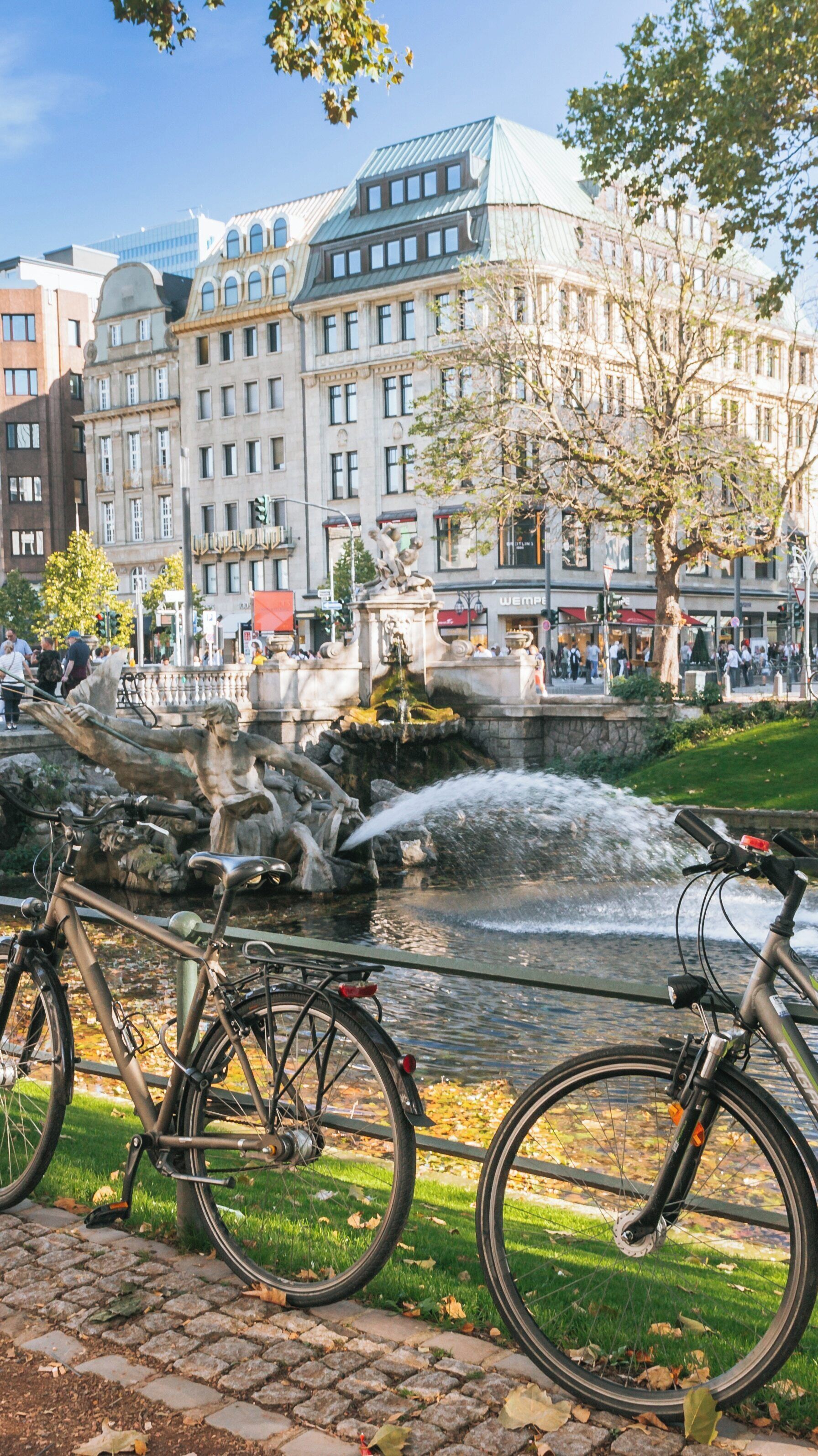 Vibrant autumn afternoon at Konigsallee in Stadtmitte, Düsseldorf, showcasing the bustling atmosphere and scenic beauty of North Rhine-Westphalia