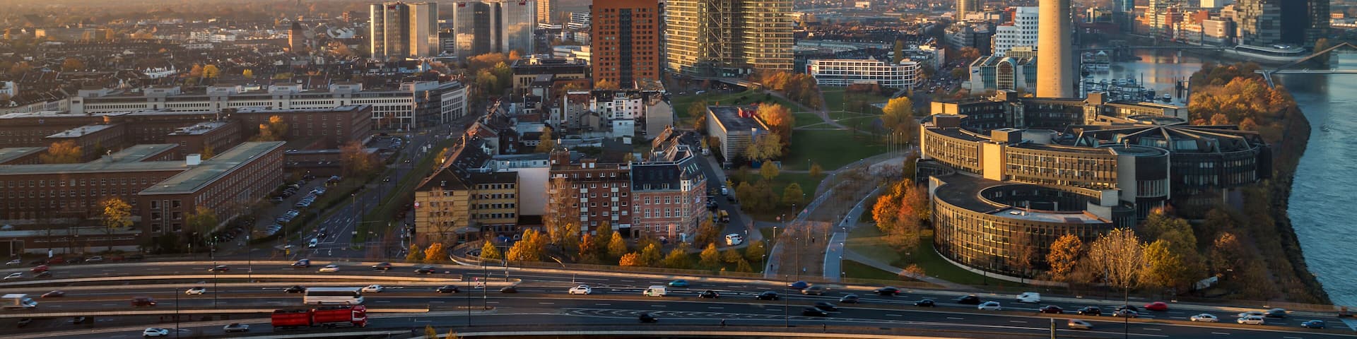 A cityscape with a prominent tower, a river, and a mix of modern and traditional architecture.