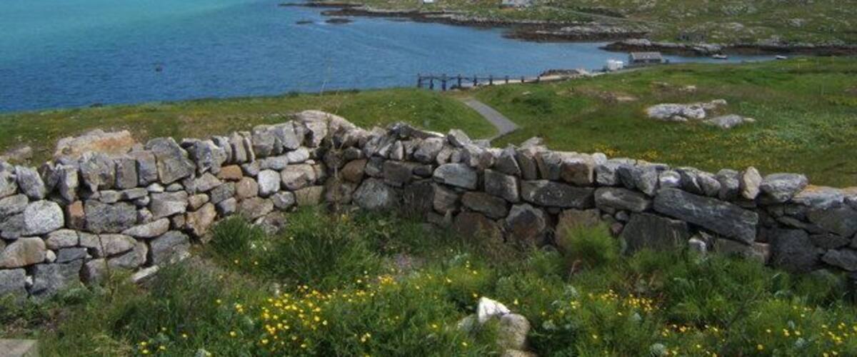 Path to the Jetty. This path leads down the jetty at Haun, below St Michael's Church 1357166. In the distance on the far side of Caolas Eiriosghaig (Kyles/Sound of Eriskay) can be seen the southeastern tip of South Uist.