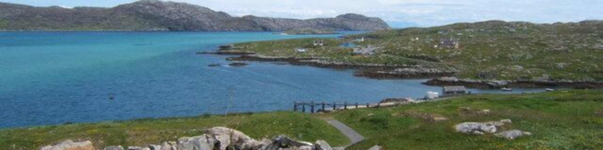 Path to the Jetty. This path leads down the jetty at Haun, below St Michael's Church 1357166. In the distance on the far side of Caolas Eiriosghaig (Kyles/Sound of Eriskay) can be seen the southeastern tip of South Uist.