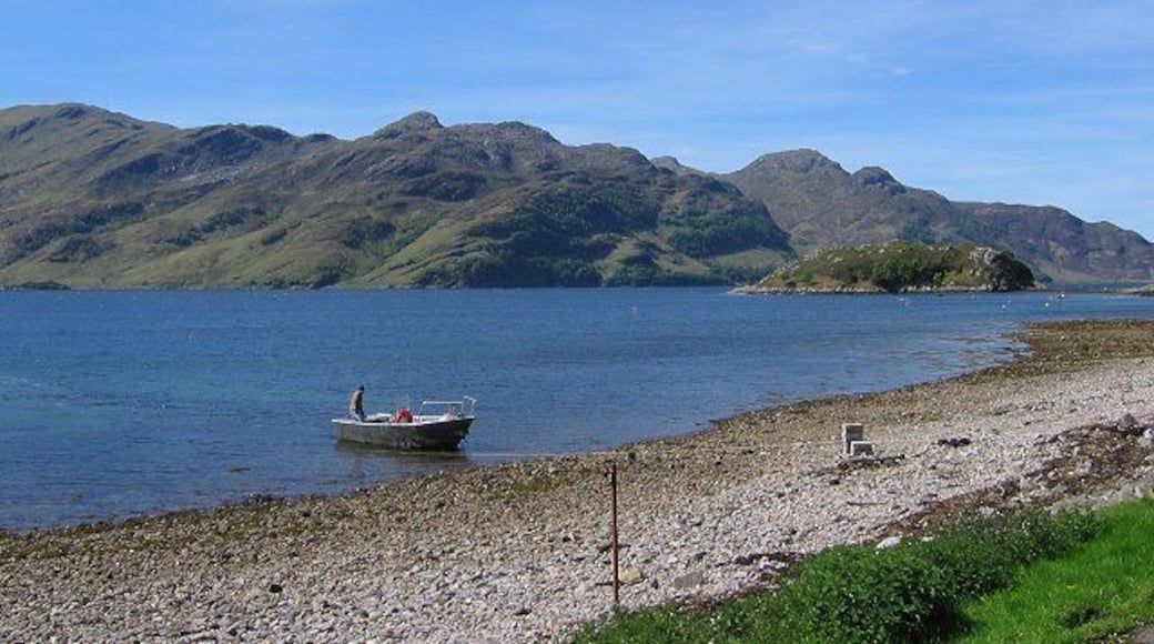 Camus Ban, Arnisdale. Beach at Arnisdale. The boat is the one used to ferry folk to and from the north shore of Knoydart - visible across Loch Hourn.