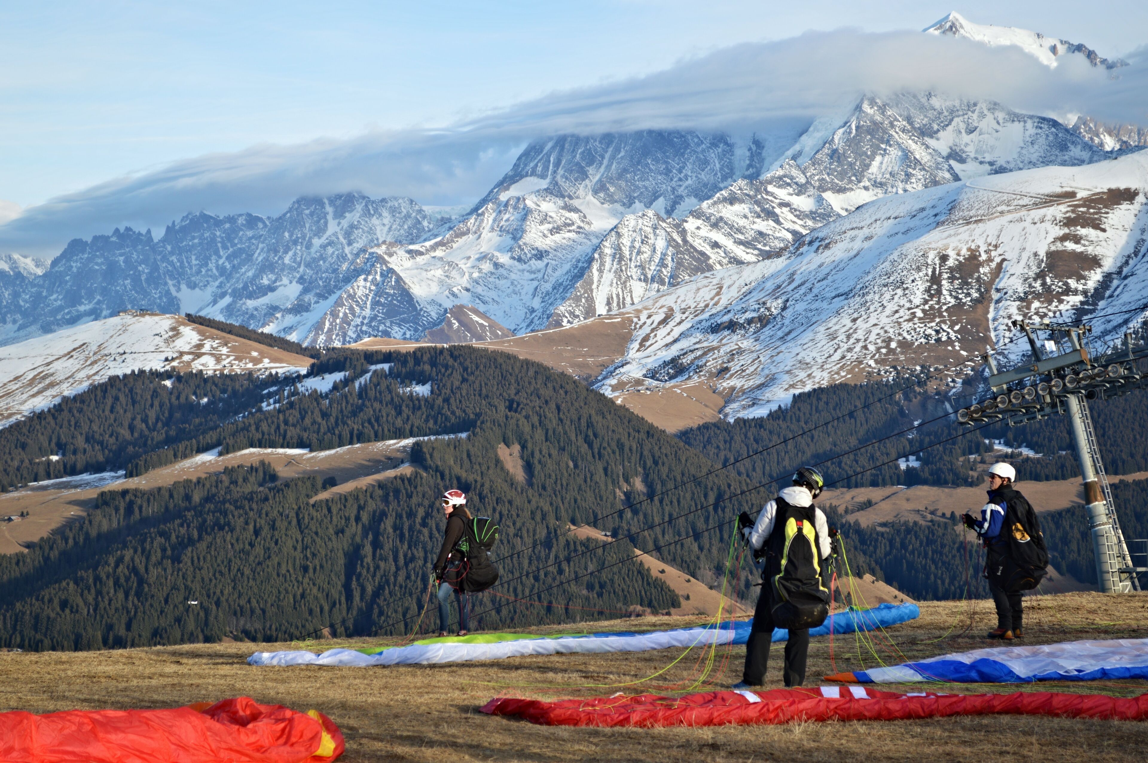 A mountainous landscape with snow-covered peaks and a clear sky.