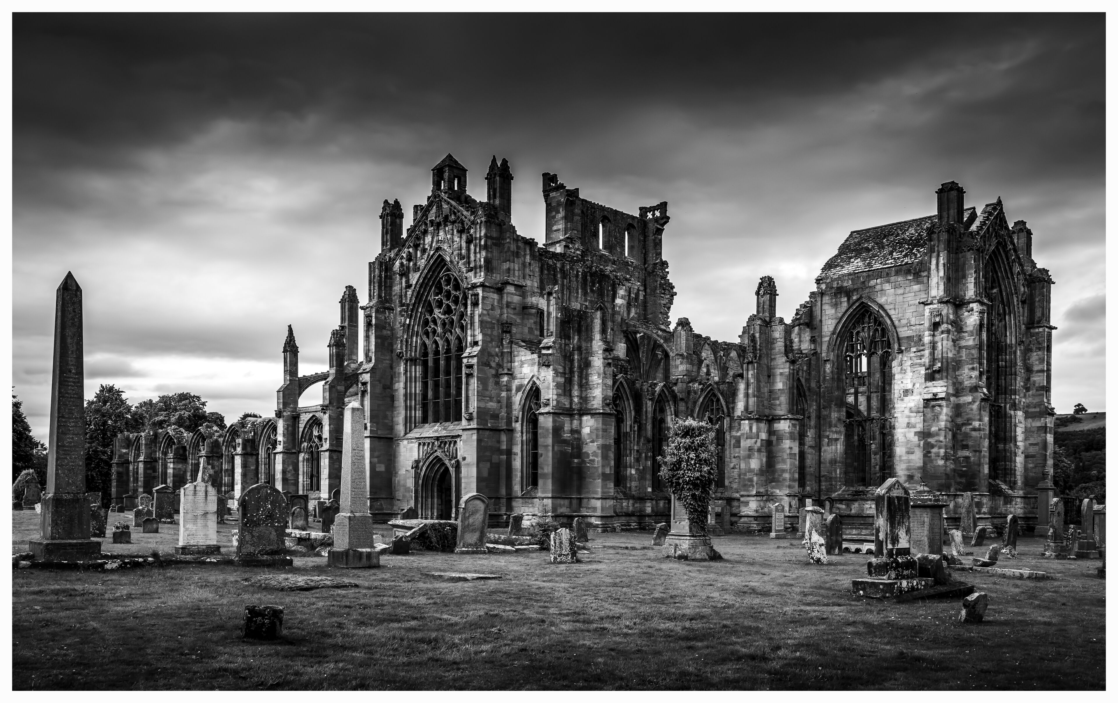 A short piece about the varied history of this outstanding example of a Scottish Historic Abbey.

Melrose Abbey, now a ruin, was once considered to be one of Scotland’s most beautiful buildings. It’s history provides the visitor with a sense of romance. It's facinating to have a walk round and try to imagine everything that has happened in the past. If only the walls could talk.

This historic Abbey is also reported to be the burial place of Robert the Bruce’s heart.

Robert The Bruce keeps getting attacked by English Monarchs and at some point saw the church being pillaged and burned by Edward II and his army in 1322. Richard the II and his amy also set fire to the abbey in 1385. Many monks were killed and David II was forced back to Edinburgh. (My Home Town).

The Abbey was eventually rebuilt over a period of about 100 years, and one person who was mostly responsible in the reconstruction was King Robert the Bruce.

Although very nice to visit on a nice sunny day it definately adds to the atmosphere on a dull and cloudy, moody day. It's almost eerie. Having a stroll through the graveyard and imagine all the stories from days gone by.

A wonderful place to visit in the Scottish borders. #History

Latitude: 55° 35' 33.59" N
Longitude: -2° 43' 2.39" W