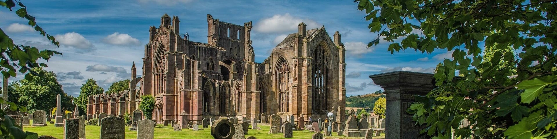A historic church with Gothic architecture amidst a cemetery.