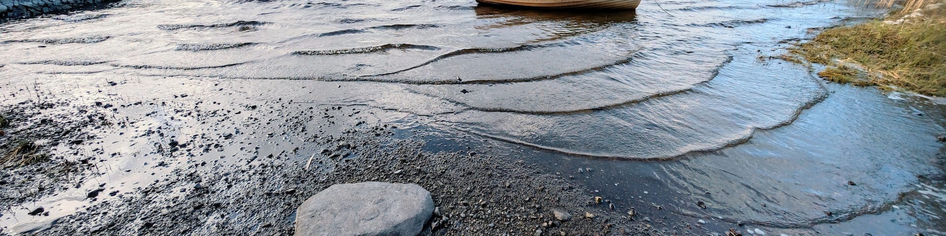 Beautiful lakeside landscape scenery, old wooden fishing boat by Oughterard pier on Corrib lake, Galway, Ireland, nature background