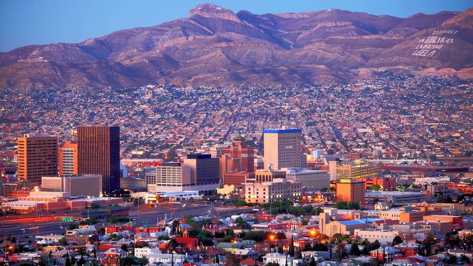 A cityscape with a mountainous backdrop.