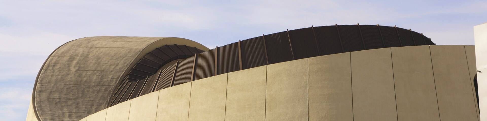 The El Paso Convention and Performing Arts Center with a distinctive curved roof and a sign indicating the Abraham Chacon Theatre.