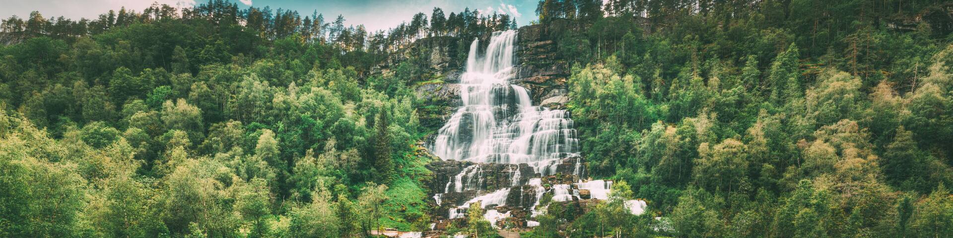 Voss, Hordaland, Norway. Waterfall Tvindefossen In Spring. Largest And Highest Waterfall Of Norway. Famous Natural Norwegian Landmark And Popular Destination. Panorama, Panoramic View