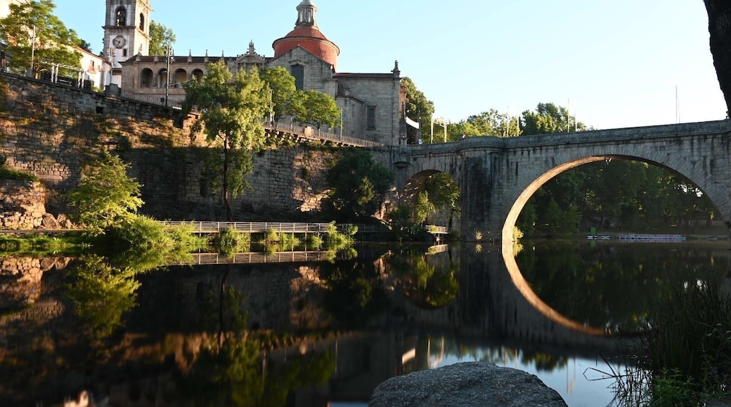 Fun shot at sunrise of Church São Gonçalo and Ponte de São Gonçalo bridge reflecting in Tamega River