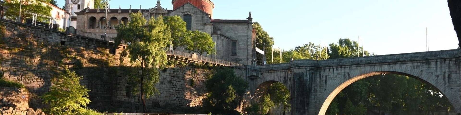 Fun shot at sunrise of Church São Gonçalo and Ponte de São Gonçalo bridge reflecting in Tamega River