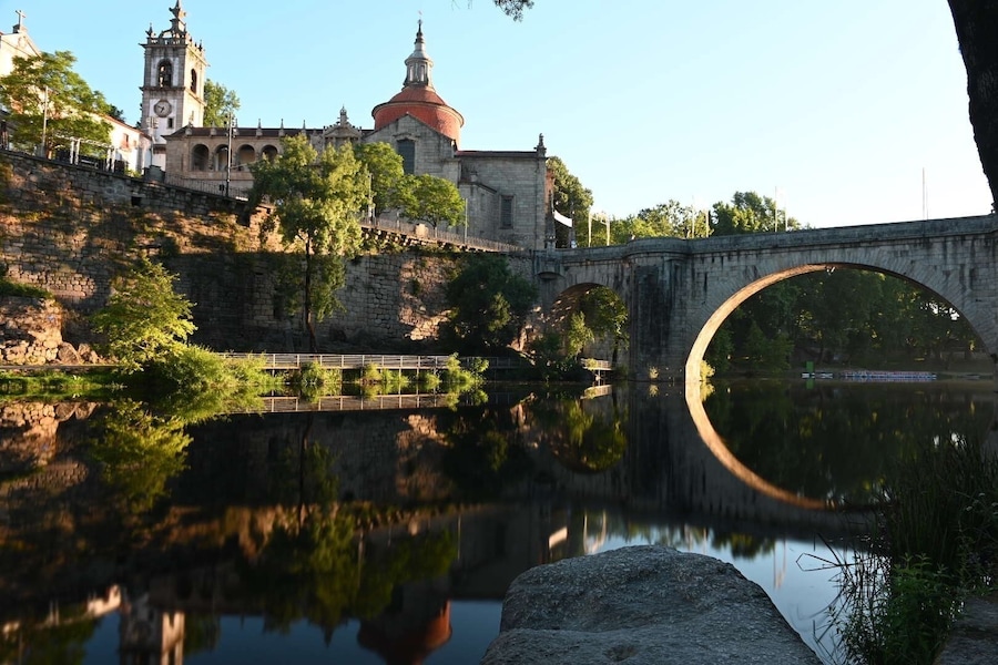 Fun shot at sunrise of Church São Gonçalo and Ponte de São Gonçalo bridge reflecting in Tamega River